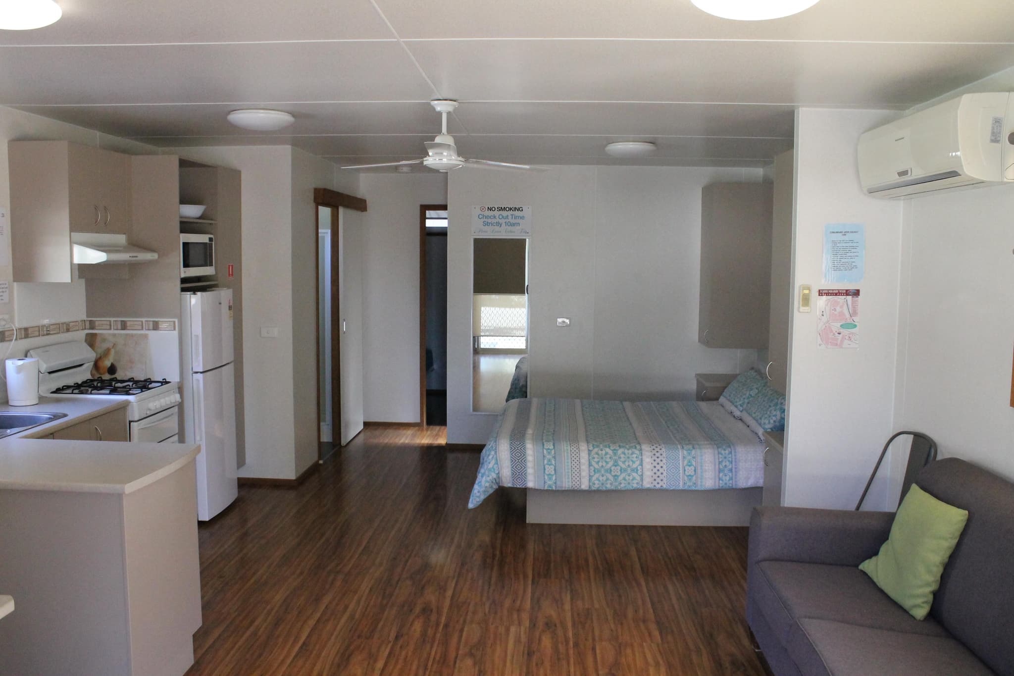 Open-plan Fleetwood Rainbow Cabin at Torrumbarry Weir Holiday Park with kitchenette, queen bed and split-system air conditioning