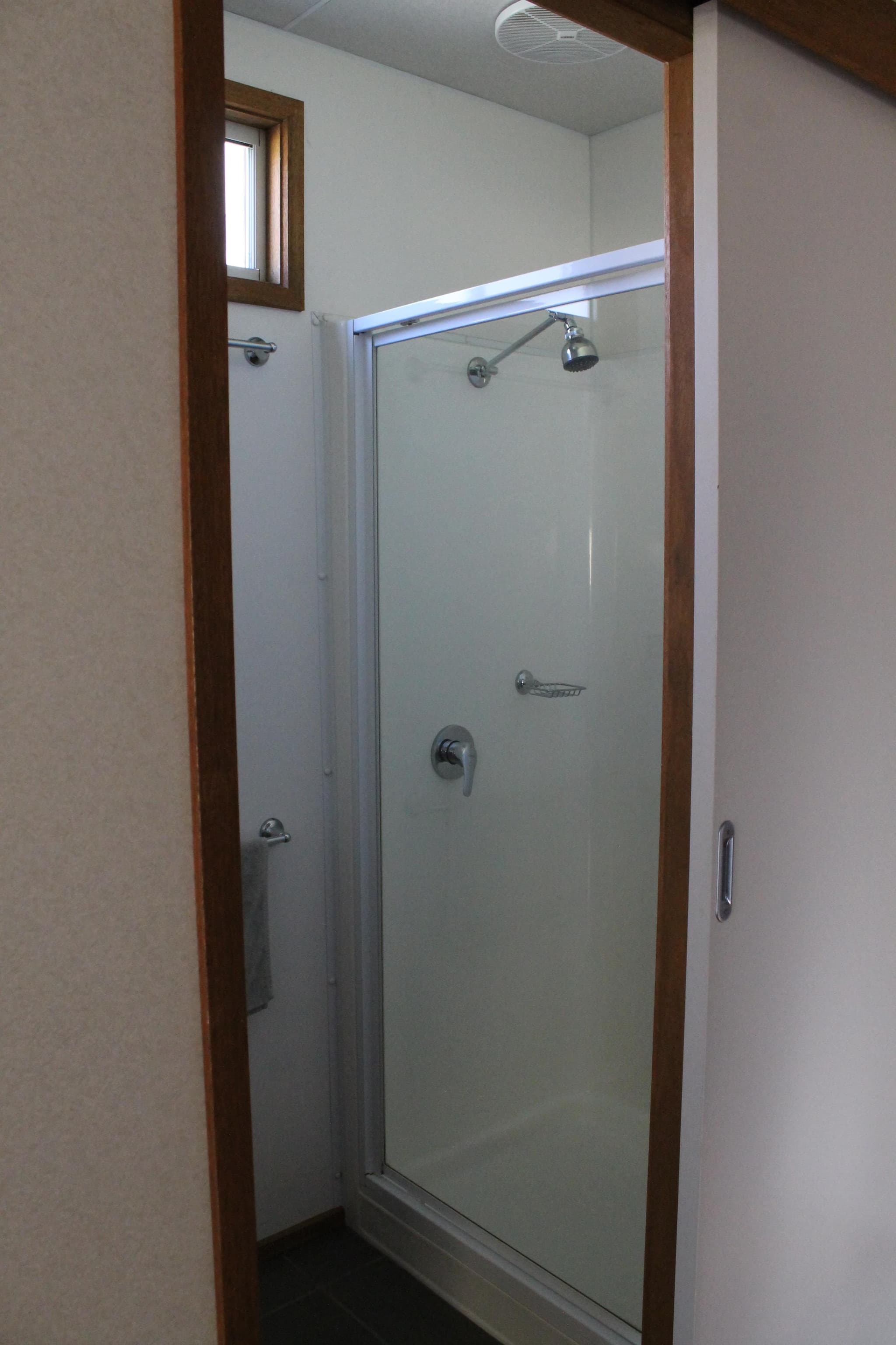 Ensuite shower with glass door and chrome fittings in the Fleetwood Rainbow Cabin at Torrumbarry Weir Holiday Park, Patho